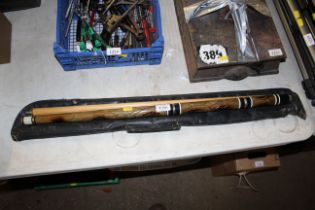 A two piece snooker cue with engravings and travel