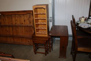 An oak drop leaf table; a nest of three occasional