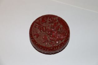 A carved cinnabar type box and cover