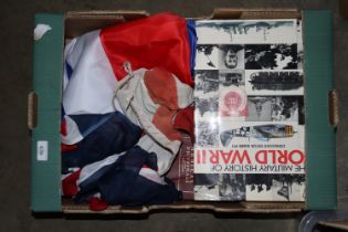 A box containing books and flags