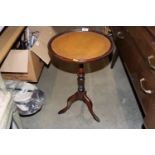 A mahogany wine table raised on tripod base