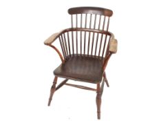 An early 19th Century elm comb back Windsor chair,