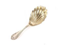 A late Victorian silver caddy spoon, having shell shaped bowl and foliate embossed handle,