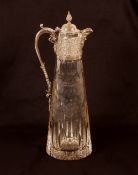 A heavy 20th Century cut crystal and silver mounted claret jug, the mount profusely decorated with