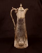 A heavy 20th Century cut crystal and silver mounted claret jug, the mount profusely decorated with