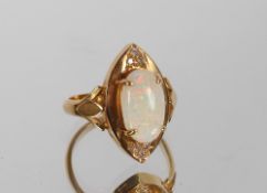 A Continental  high grade gold opal and diamond ring, the central Marquise shaped panel with three