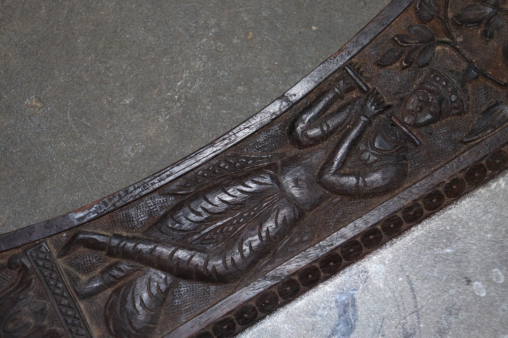 A carved Eastern wall mirror, profusely decorated - Image 2 of 2