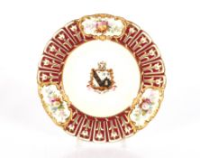 A 19th Century porcelain cabinet plate, with painted floral panels and central armorial crest;