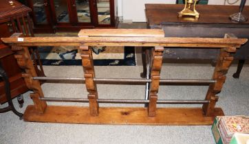 A 19th Century pine spit rack, with four arched supports and shelf base, complete with two iron