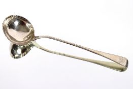 An 18th Century Scottish silver ladle, the bowl with scalloped edge, the handle with ship crest