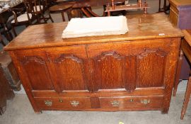 An 18th Century oak mule chest, with hinged lifting lid above four fielded panels with central