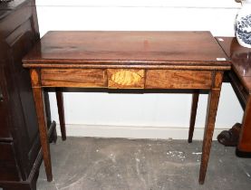 A 19th Century mahogany and satin wood inlaid fold over card table, raised on square tapering