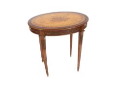 A French walnut satin wood and inlaid oval occasional table, having gilt metal mounts raised on