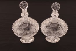 A pair of heavy cut crystal decanters, with profuse hobnail pattern and fruit and foliage decoration