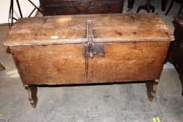 A 17th Century oak ark shaped coffer, having iron strap hinges and hasps above shaped stile end