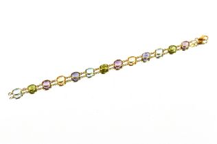 A 18ct gold bracelet set with various precious and semi-precious stones including amethyst,