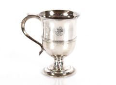 A George III silver baluster mug, decorated with a family crest above a  central girdle, scrolled
