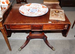 A Regency mahogany and ebony strung sofa table, fitted two frieze drawers and raised on U shaped