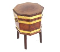 A George III mahogany and brass bound wine cooler of octagonal shape, lead lined interior raised