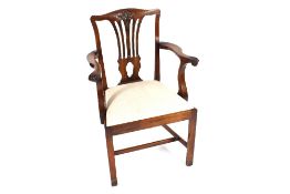 A set of eight Chippendale design mahogany dining chairs, carved foliate motifs to the cresting