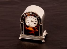 A silver and tortoiseshell mantel clock, by Elkington & Co. of arched form with ball feet, London