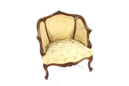 A 19th Century walnut boudoir chair, having carved foliate cresting, floral stamped velour