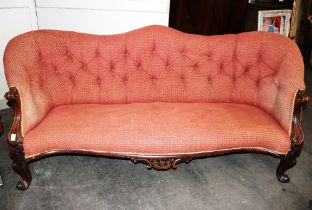 A Victorian walnut couch, having shaped button back upholstered in rouge velour, scrolled arms above