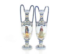 Henriot Quimper, a pair of vases brightly coloured decoration of figures and flowers with loop