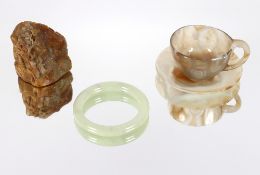 An antique Chinese soapstone boulder carving; a pale celadon hardstone bangle and a finely worked
