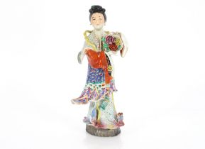 A Japanese porcelain model of a Geisha girl holding a basket of flowers, 33cm high
