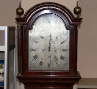 A Georgian mahogany and satin wood inlaid long case clock, the arched hood surmounted by brass