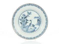 A London Delftware plate, the central field decorated with a bird in landscape, stylised flowers