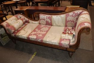 A 19th Century simulated rosewood and brass inlaid scroll end couch, raised on turned tapering