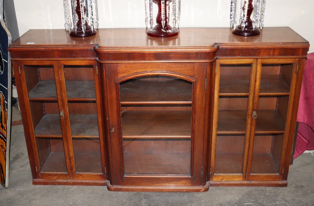A 19th Century mahogany breakfront alcove cabinet, enclosed by glazed panelled doors, 150cm wide x