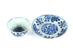 An 18th Century Chinese blue and white cup and saucer, with prunus decoration