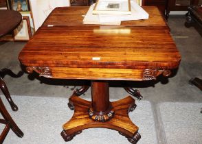 A Victorian rosewood fold over tea table with swiv