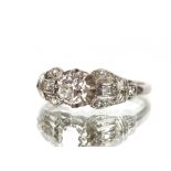 An antique platinum diamond solitaire ring, the central diamond in 8 claw setting with split and