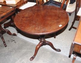 A George III mahogany tripod occasional table, raised on birdcage movement and baluster column