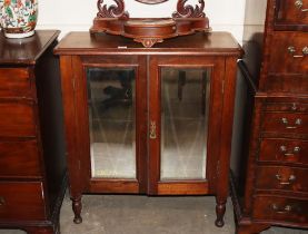 A late Victorian mahogany side cabinet, the interior shelves enclosed by a pair of bevelled mirror