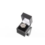 An impressive 18ct gold Hallmarked diamond encrusted ring, of layered floral design, total diamond