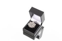 An impressive 18ct gold Hallmarked diamond encrusted ring, of layered floral design, total diamond