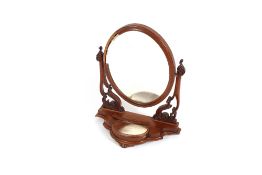 A Victorian mahogany oval swing toilet mirror, raised on a serpentine base with drop flap trinket
