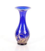 A Venetian blue glass and gilt decorated baluster vase, the flared neck with cream spiral glass
