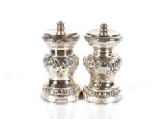 A matched pair of silver salt and pepper mills, Birmingham 1900 and 1925