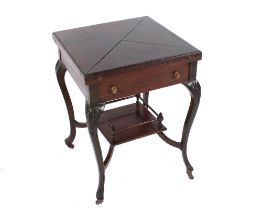 An Edwardian mahogany envelope card table, raised on carved shoulders and cabriole supports,