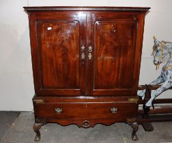 A 19th Century mahogany press cupboard, the fielded panel doors enclosing a shelved interior, single