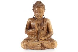 A large carved wooden figure of a seated Buddha, 52cm high