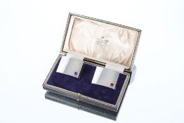 A cased pair of unusual silver napkin rings, each set with semi precious stone, amethyst and