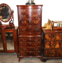 A mahogany serpentine fronted chest on chest on two sections, fitted eight drawers and a brushing