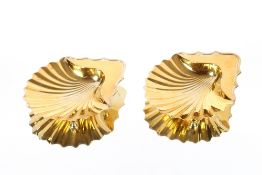 An unusual pair of George III silver gilt shell shaped butter dishes, raised on ball feet,